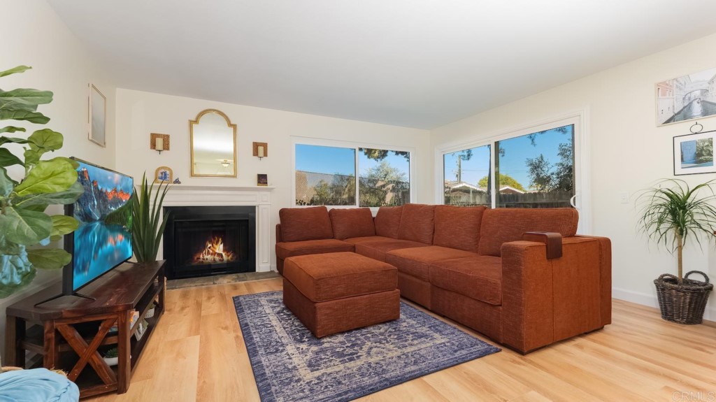 322 Ivy Lane Fallbrook, CA 92028 - Photo 16 of 35 a living room with furniture a fireplace and a potted plant