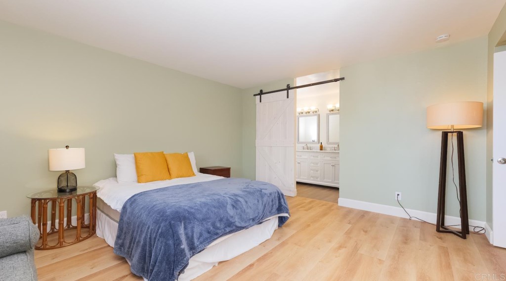 322 Ivy Lane Fallbrook, CA 92028 - Photo 18 of 35 a bedroom with a bed and a lamp