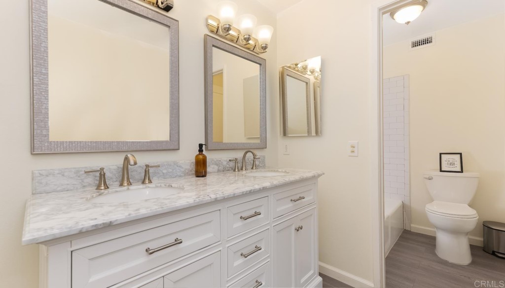 322 Ivy Lane Fallbrook, CA 92028 - Photo 21 of 35 a bathroom with a granite countertop sink a toilet and a mirror