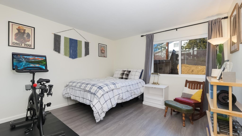 322 Ivy Lane Fallbrook, CA 92028 - Photo 23 of 35 a bedroom with a bed window and a flat screen tv