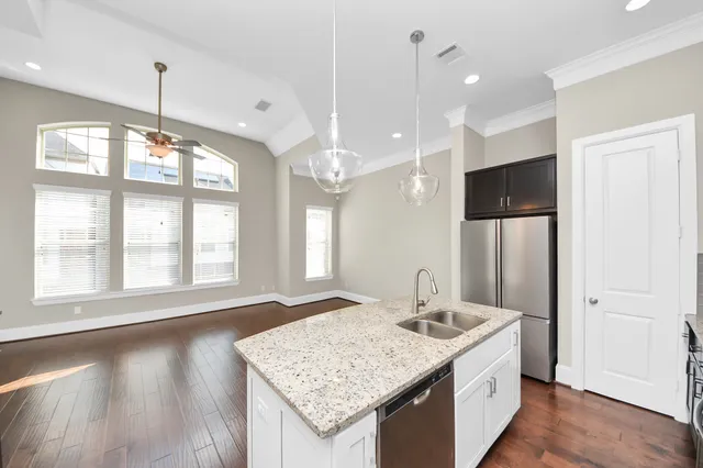 a bathroom with a granite countertop sink and a large mirror