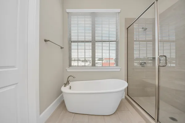 a white bath tub sitting next to a window