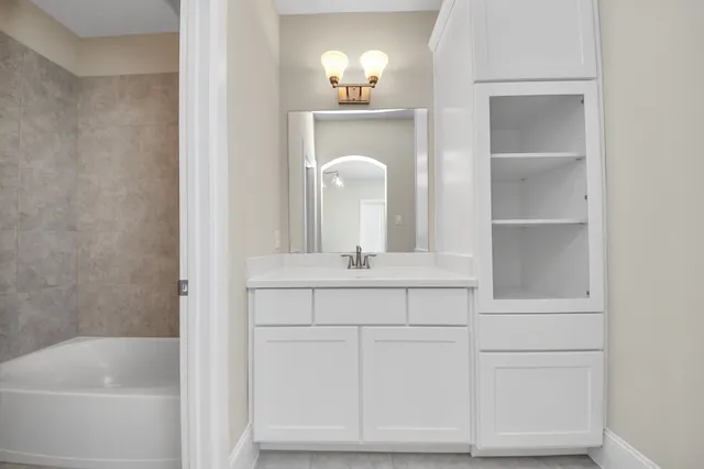 a bathroom with a sink and a mirror