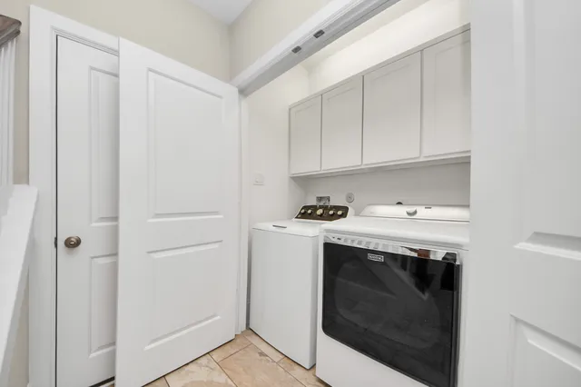 a utility room with sink dryer and washer