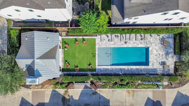 an aerial view of a house with a yard