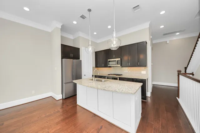 a kitchen with a stove a sink and a refrigerator