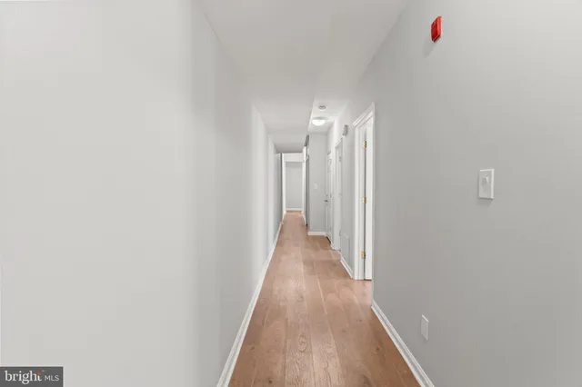a view of a hallway with wooden floor