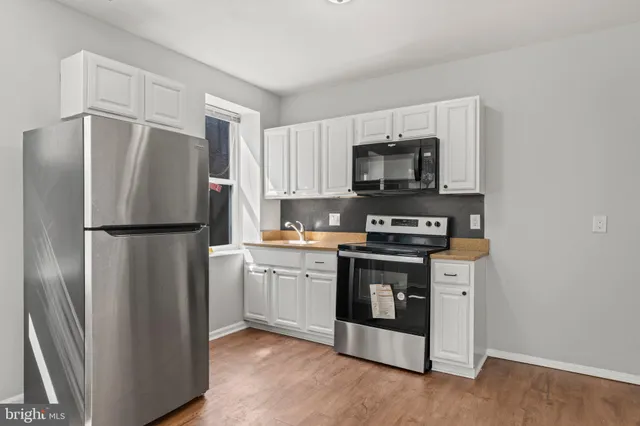 a kitchen with stainless steel appliances granite countertop a refrigerator stove and microwave