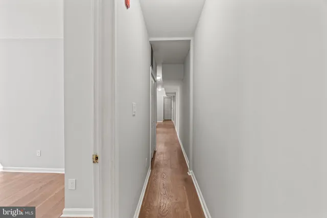a view of a hallway with wooden floor