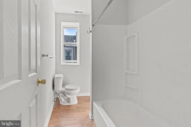 a bathroom with a bathtub and a toilet