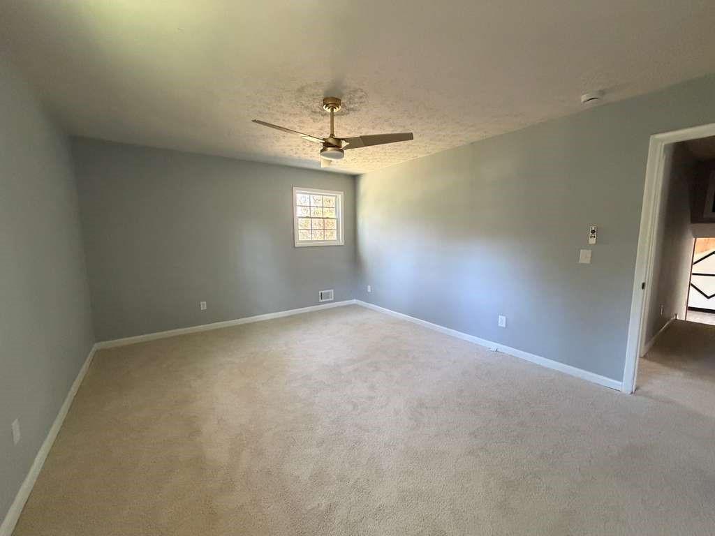 7367 Rountree Drive Riverdale, GA 30274 - Photo 11 of 18 an empty room with a window and a ceiling fan