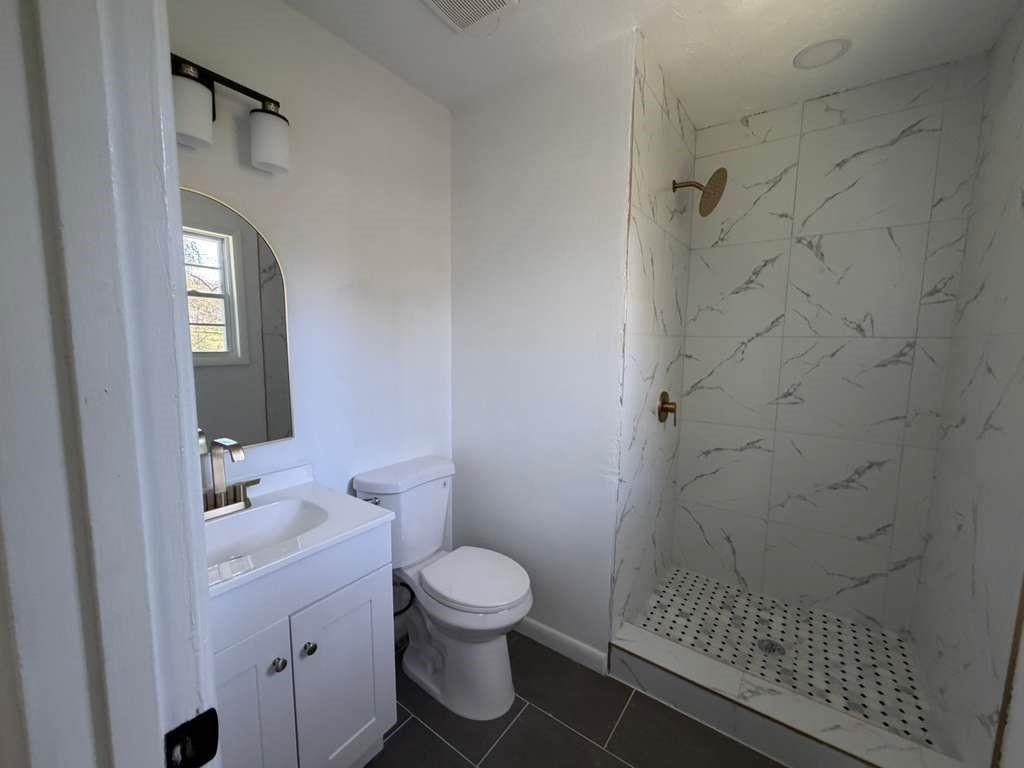 7367 Rountree Drive Riverdale, GA 30274 - Photo 12 of 18 a bathroom with a toilet and a shower