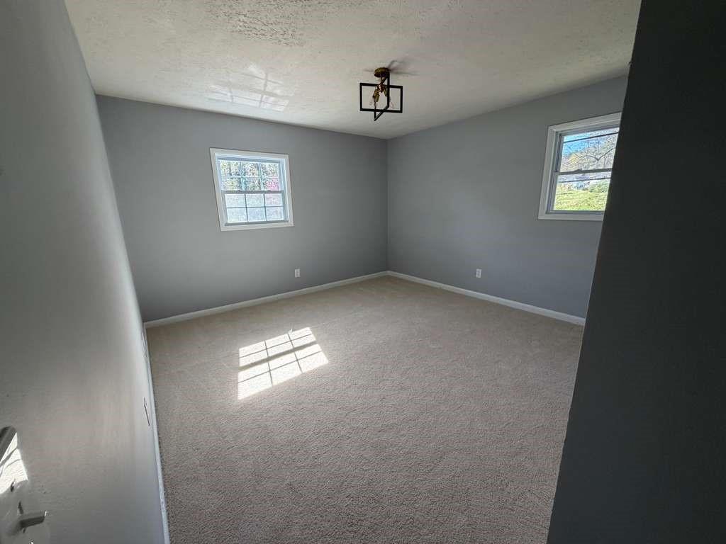 7367 Rountree Drive Riverdale, GA 30274 - Photo 14 of 18 an empty room with windows and closet