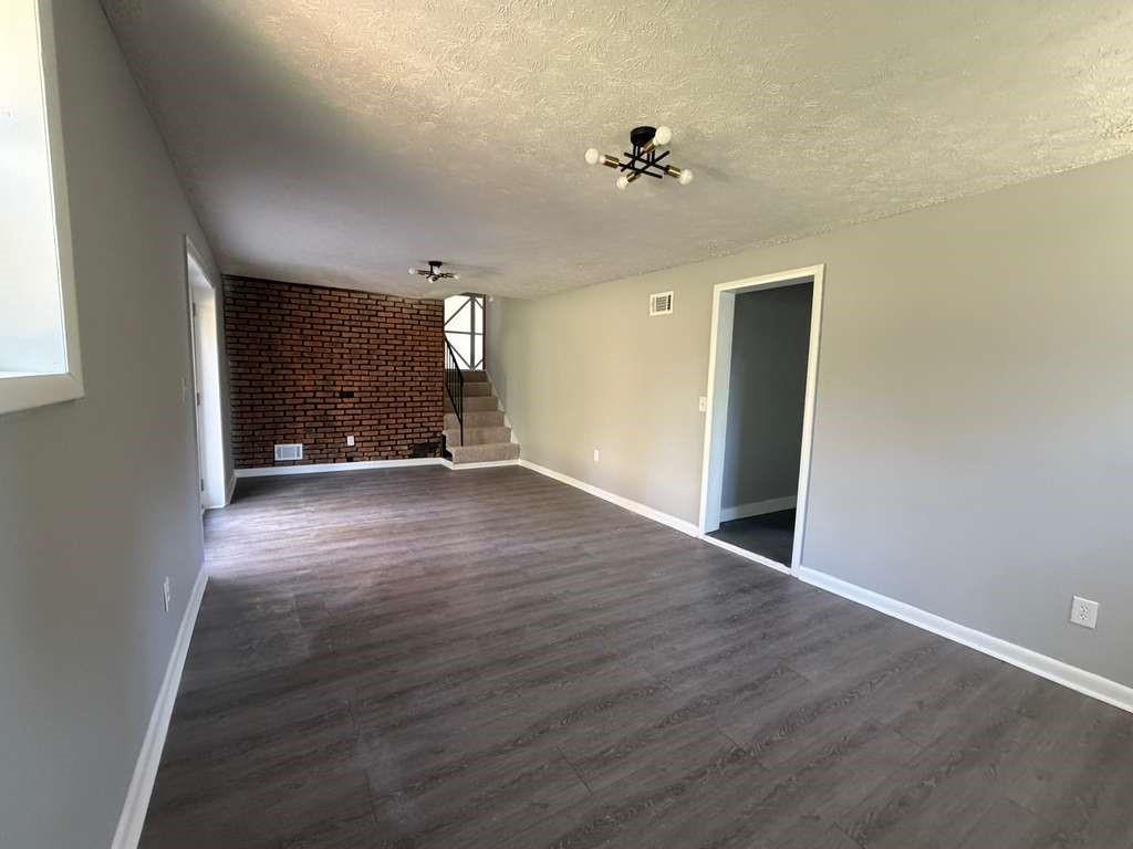 7367 Rountree Drive Riverdale, GA 30274 - Photo 16 of 18 a view of an empty room with wooden floor