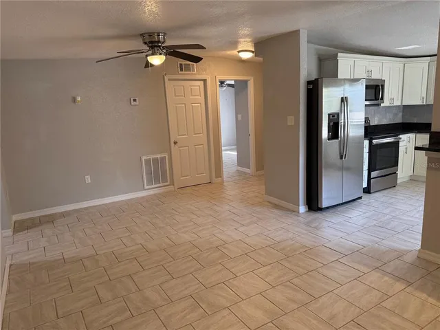 a kitchen with stainless steel appliances a sink and cabinets
