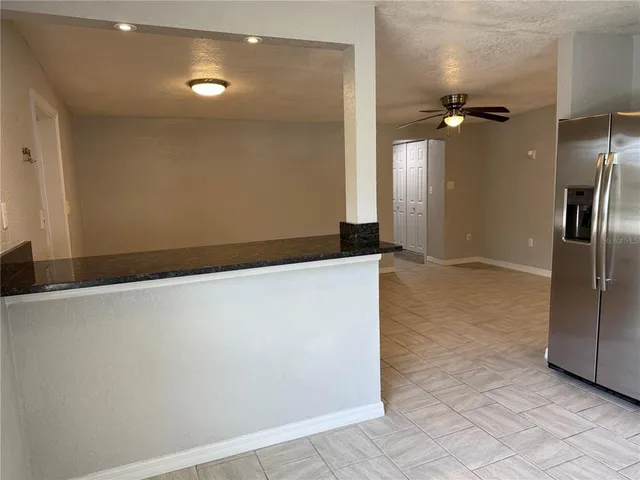 a kitchen with stainless steel appliances a refrigerator and a stove top oven