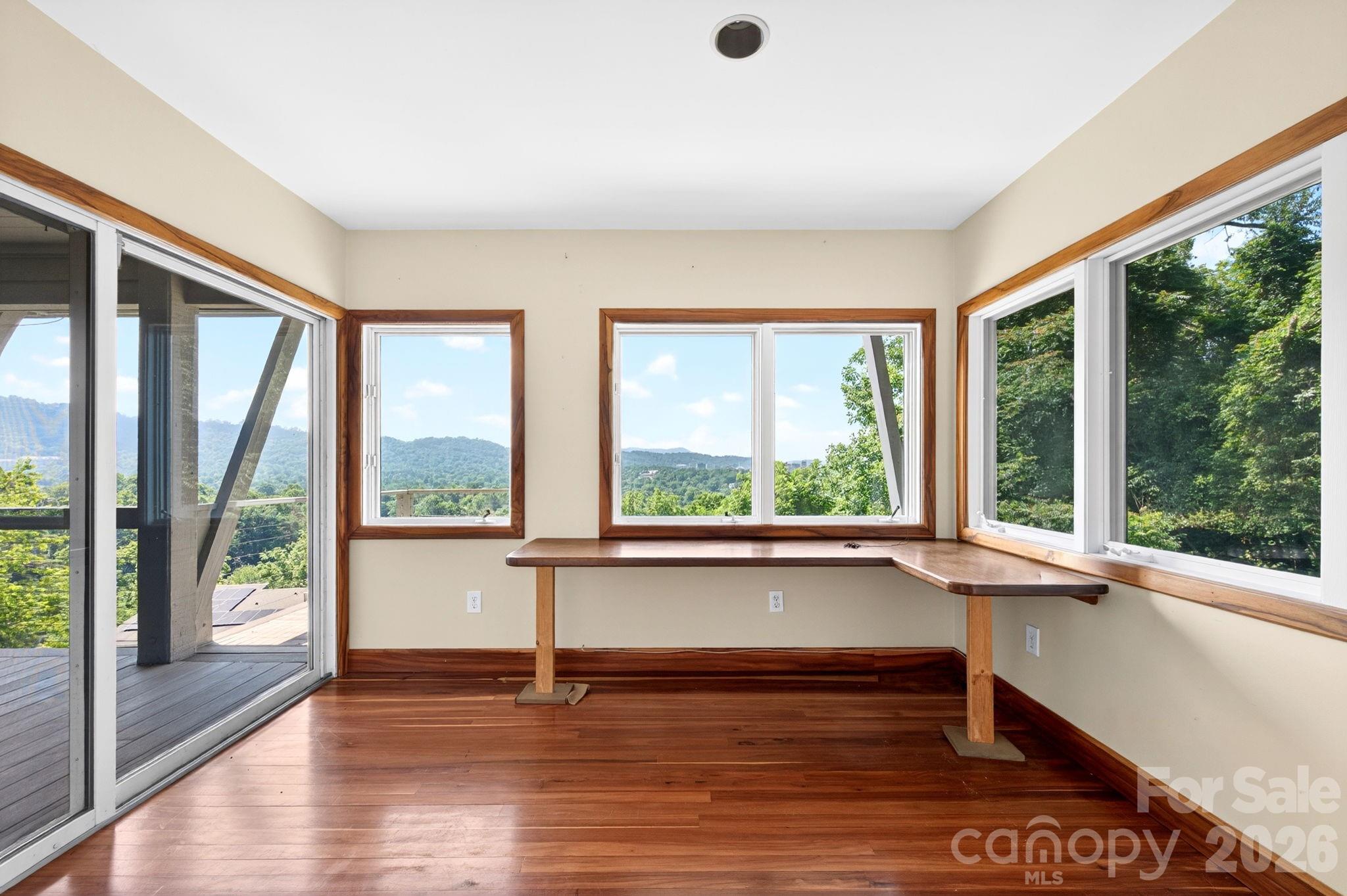 38 Lookout Road Asheville, NC 28804 - Photo 24 of 34 a view of an empty room with wooden floor and a large window