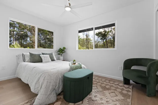 a bedroom with a bed mirror and window