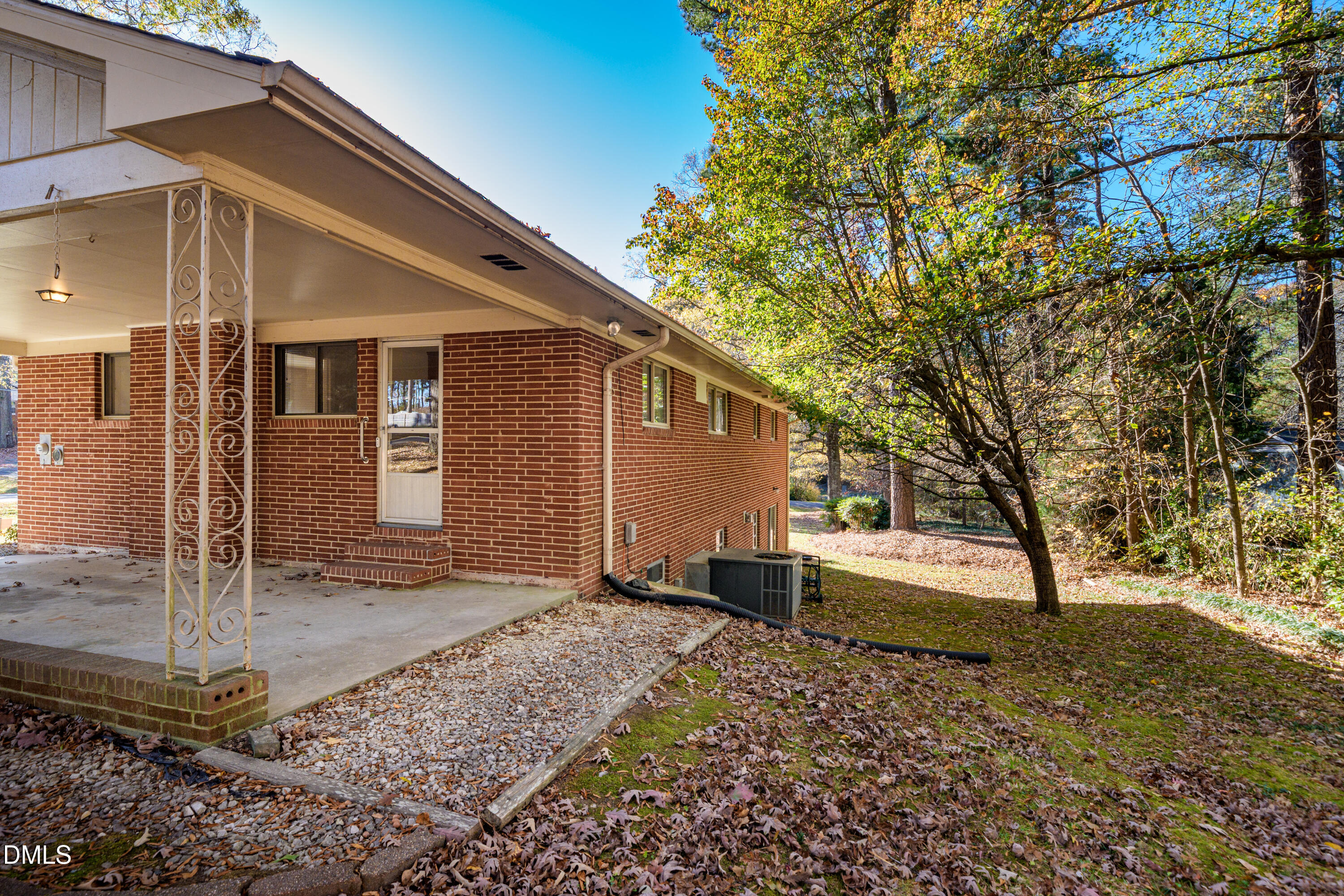 4714 West Hills Drive Durham, NC 27705 - Photo 22 of 27 a backyard of a house with barbeque oven table and chairs
