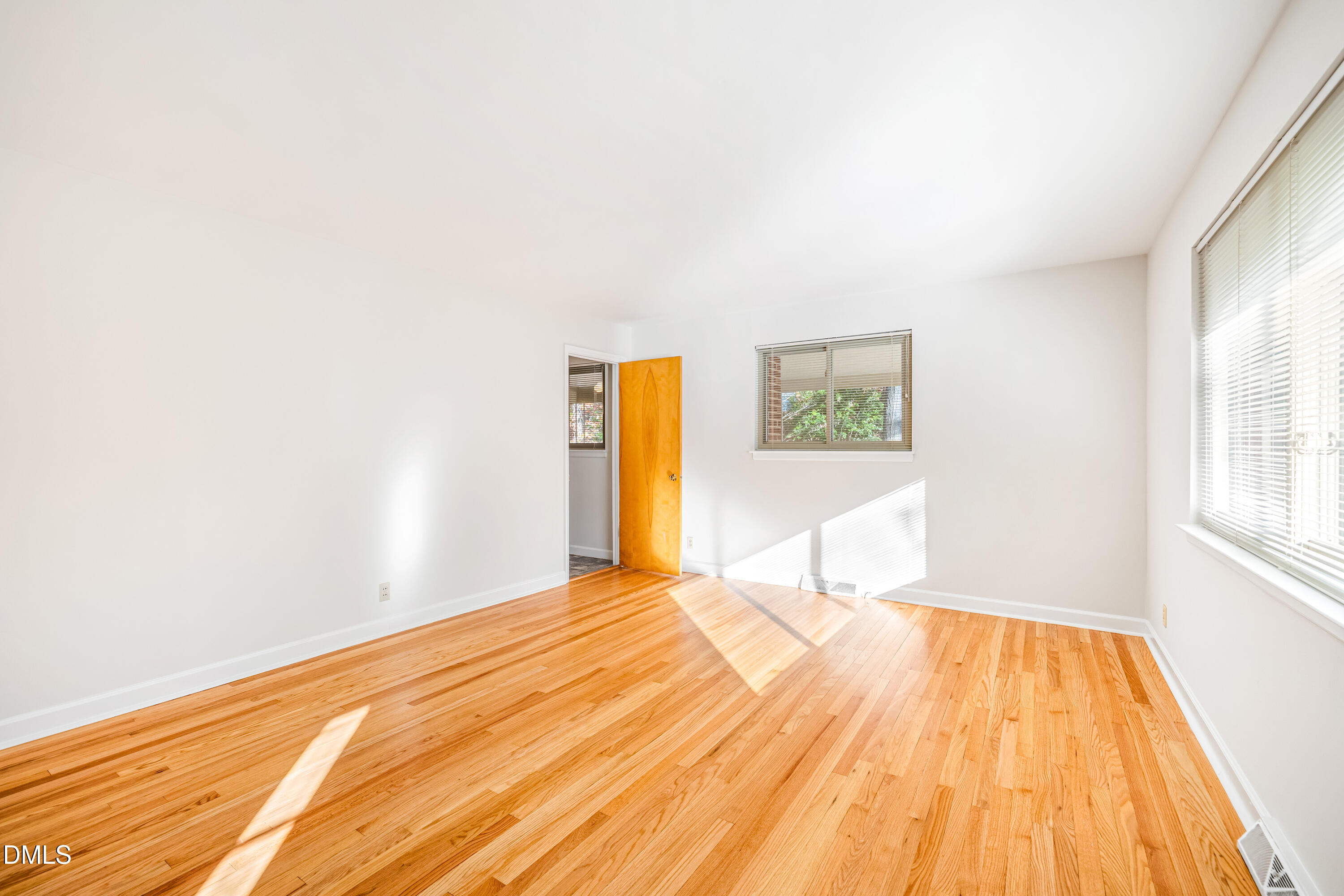 4714 West Hills Drive Durham, NC 27705 - Photo 4 of 27 a bedroom with a bed and a wooden floor