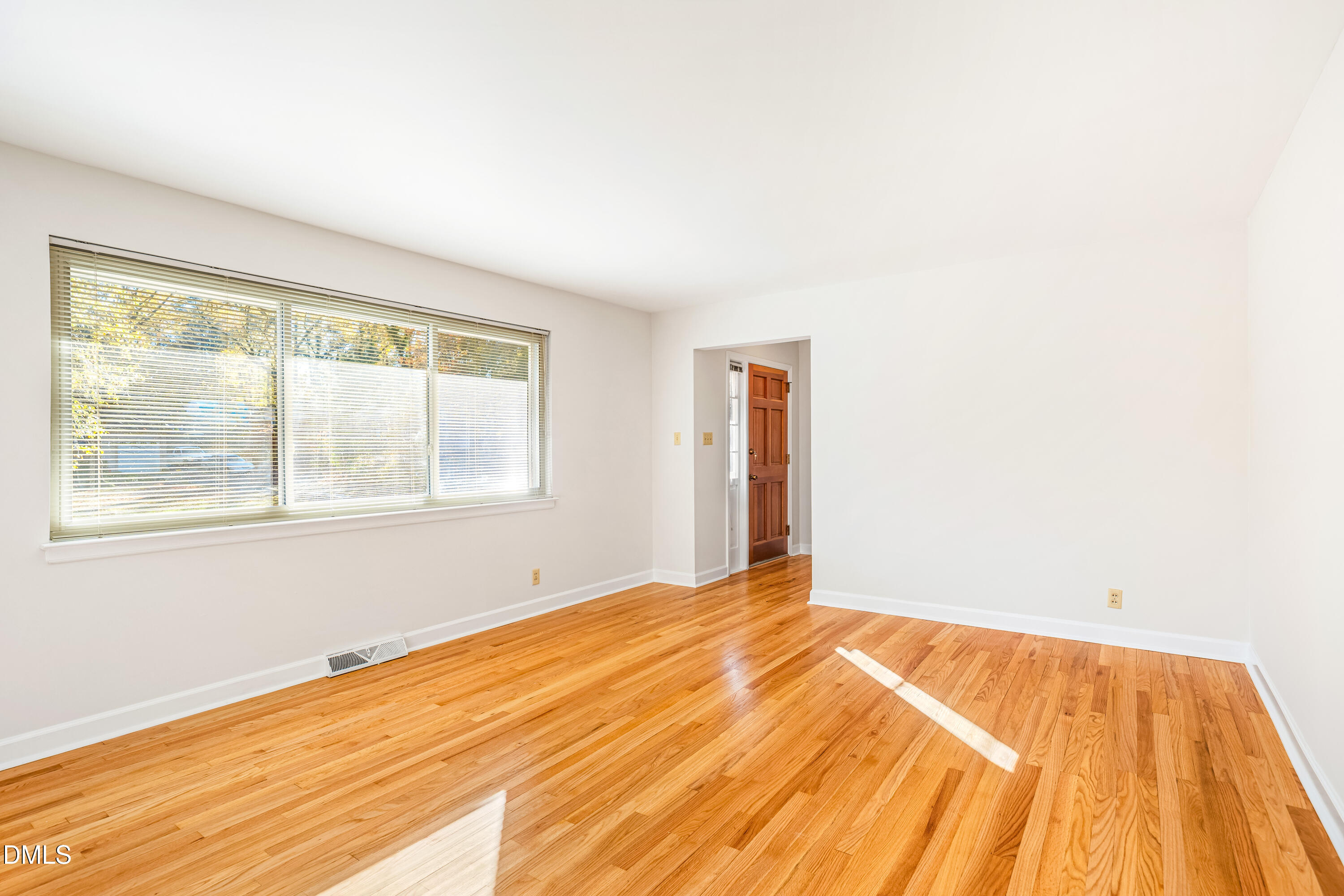 4714 West Hills Drive Durham, NC 27705 - Photo 5 of 27 a view of an empty room with wooden floor and a window