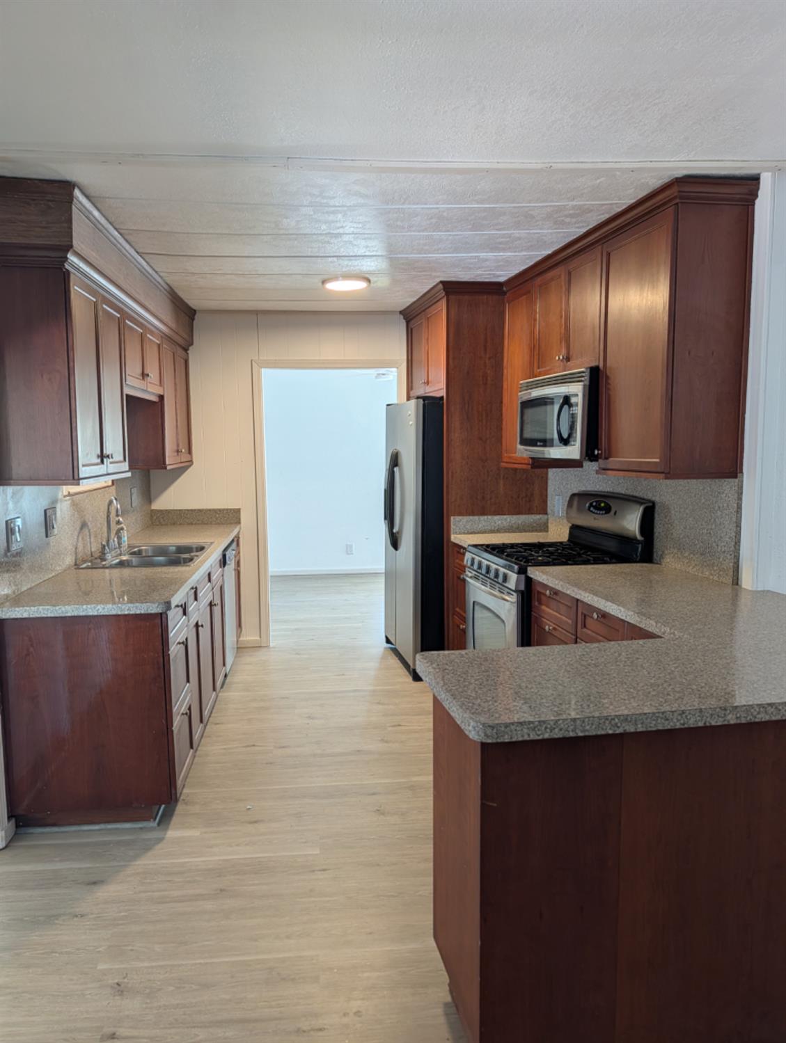9484 99 Frontage Road, Unit 36 Stockton, CA 95212 - Photo 5 of 8 a kitchen with stainless steel appliances granite countertop a sink stove and refrigerator
