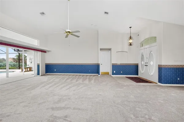 a large white kitchen with cabinets and stainless steel appliances