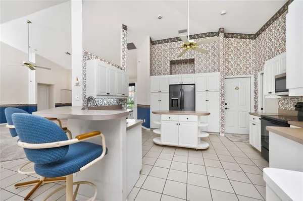 a kitchen with granite countertop white cabinets and appliances
