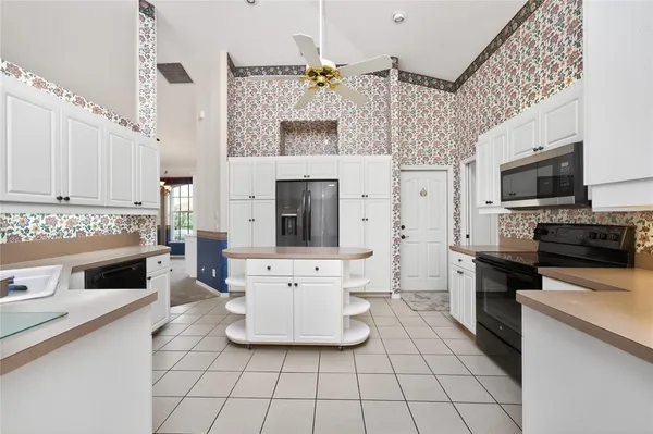 a kitchen with a sink appliances and cabinets
