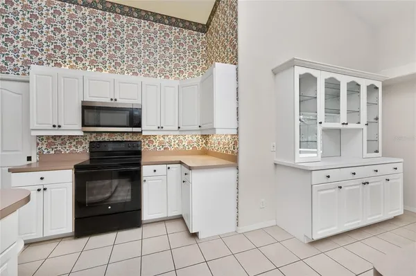 a view of a livingroom with kitchen and furniture