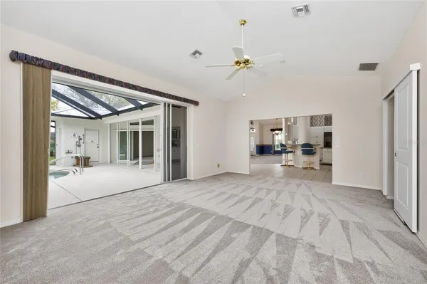 a spacious bedroom with a large bed and a large window