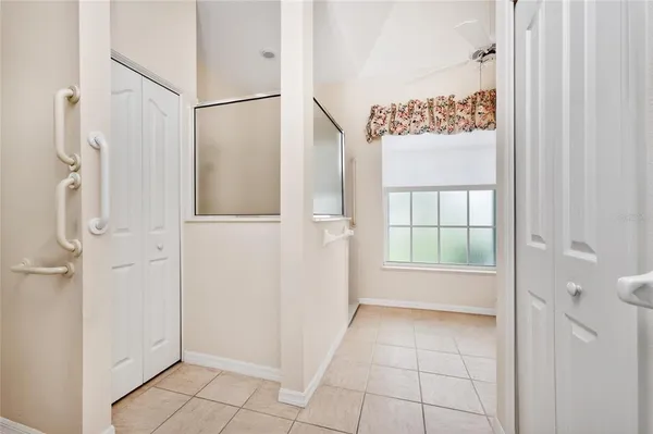 an empty room with a ceiling fan and a window