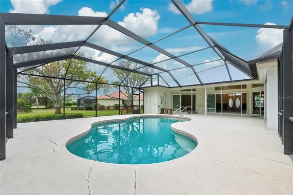 an aerial view of a residential houses with outdoor space and lake view