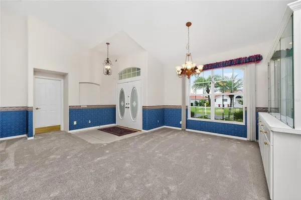 a view of a livingroom with furniture and a kitchen