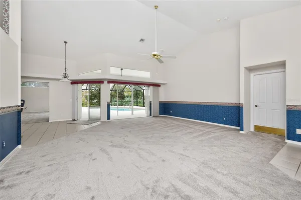 a view of empty room with cabinet and windows