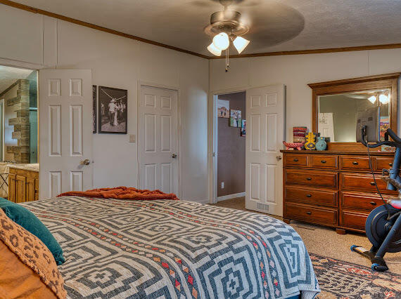 6341 Farm Private Road Levelland, TX 79336 - Photo 17 of 46 a bedroom with a bed and a dresser in it