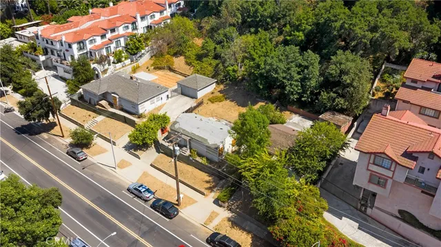 an aerial view of multiple houses with yard