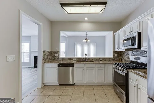 a kitchen with stainless steel appliances cabinets a sink and a stove