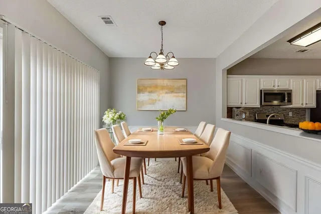 a view of a dining room with furniture window and wooden floor