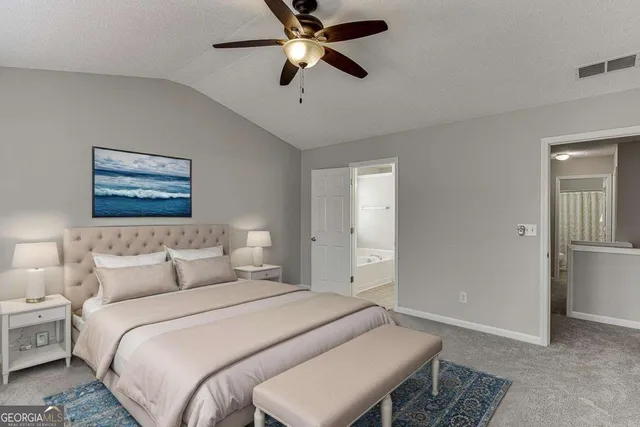 a bedroom with a bed and a painting on the wall