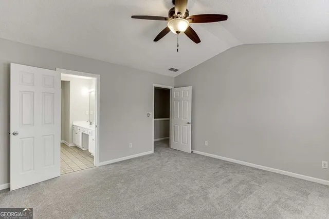 an empty room and chandelier fan