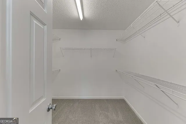 a bathroom with a double vanity sink a large mirror and a bathtub