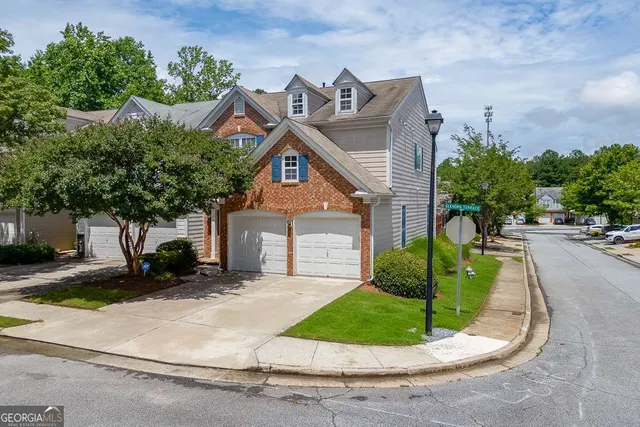 a view of a house with a yard and garage