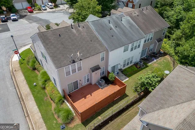 an aerial view of a house with garden space and sitting area