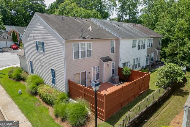 a view of house with outdoor seating and green space