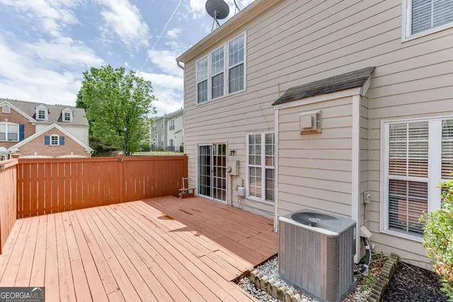 a view of a house with a wooden deck