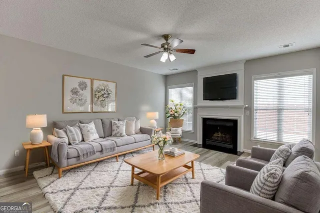 a living room with furniture a fireplace and a flat screen tv