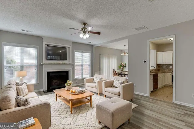 a living room with furniture fireplace and a flat screen tv