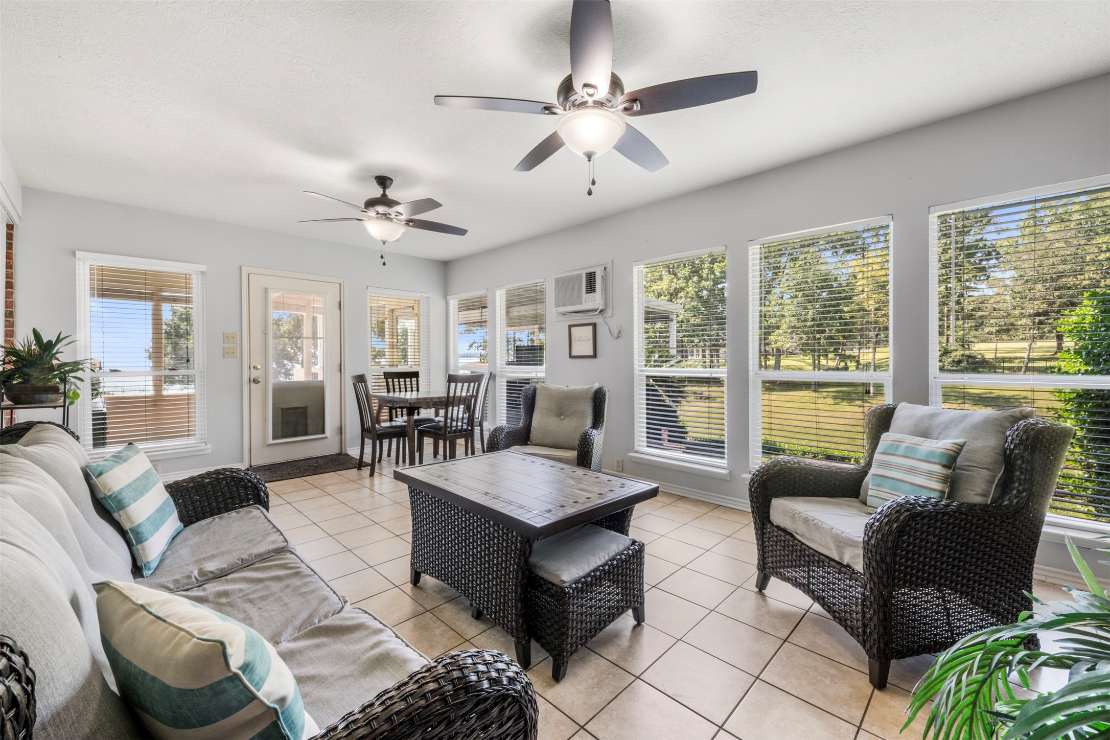 381 West Lake Drive Point Blank, TX 77364 - Photo 14 of 33 Another angle of the sunroom highlights its easy access to the outdoors and plentiful natural light. Perfect for a sitting area, reading nook, or casual dining space with a view.