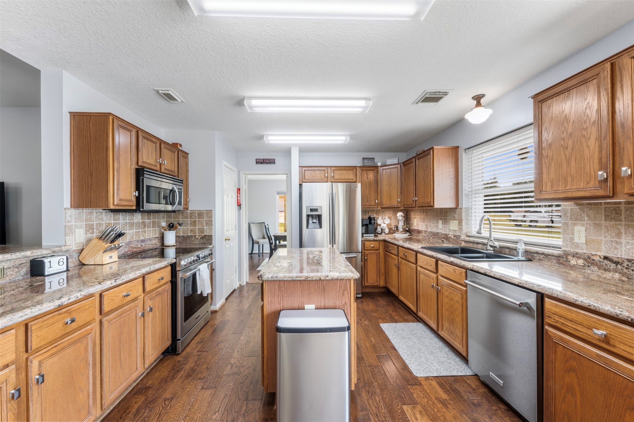 381 West Lake Drive Point Blank, TX 77364 - Photo 6 of 33 This kitchen truly delivers on storage and style, featuring custom cabinetry, updated stainless steel appliances, and granite counters.